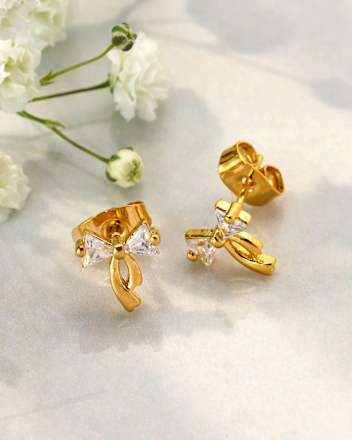 Vergulde strikvormige oorbellen met glitter, 2 stuks
